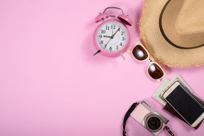 Close-up of clock on table against wall