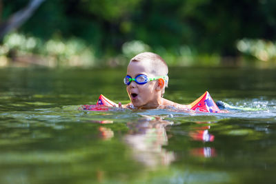 Portrait of woman swimming in lake