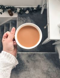 Midsection of person holding tea cup