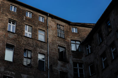 Low angle view of residential buildings against blue sky