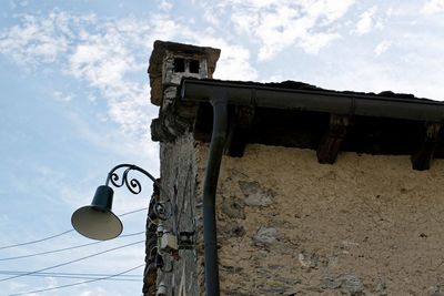 Low angle view of telephone pole against sky