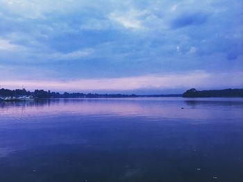 Scenic view of lake against cloudy sky