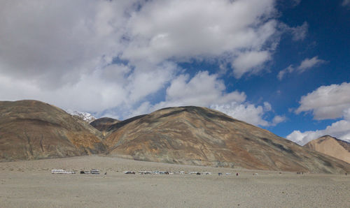 Scenic view of land and mountains against sky