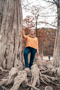 Portrait of people by tree trunk
