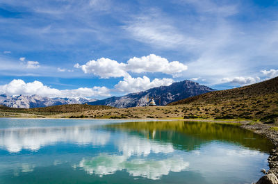 Scenic view of dhankar lake by mountain against sky