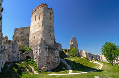 Old ruins of building against clear blue sky