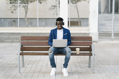 Full length of young man using mobile phone