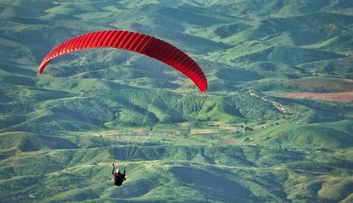 Person paragliding over mountains