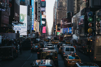 Traffic on city street amidst buildings