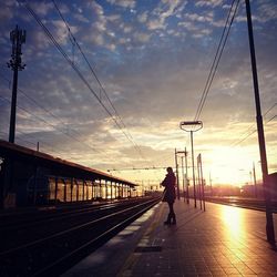 People walking on road at sunset