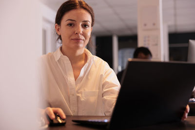 Young woman using laptop at office