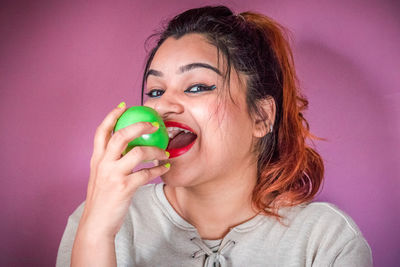 Portrait of young woman holding ice cream