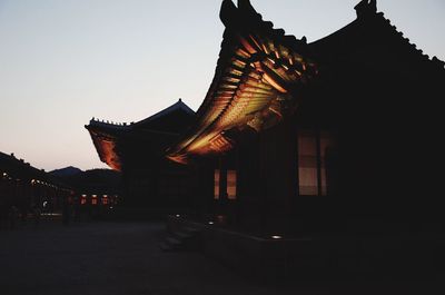 Low angle view of illuminated temple building against clear sky