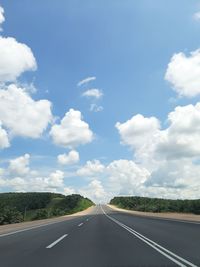 Empty road along landscape against sky