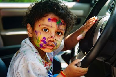 Close-up portrait of young woman in car