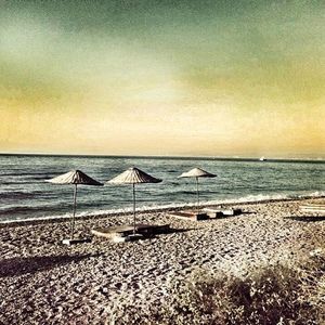 Scenic view of beach against sky during sunset