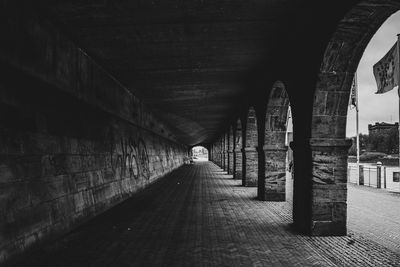 Rear view of man walking in tunnel