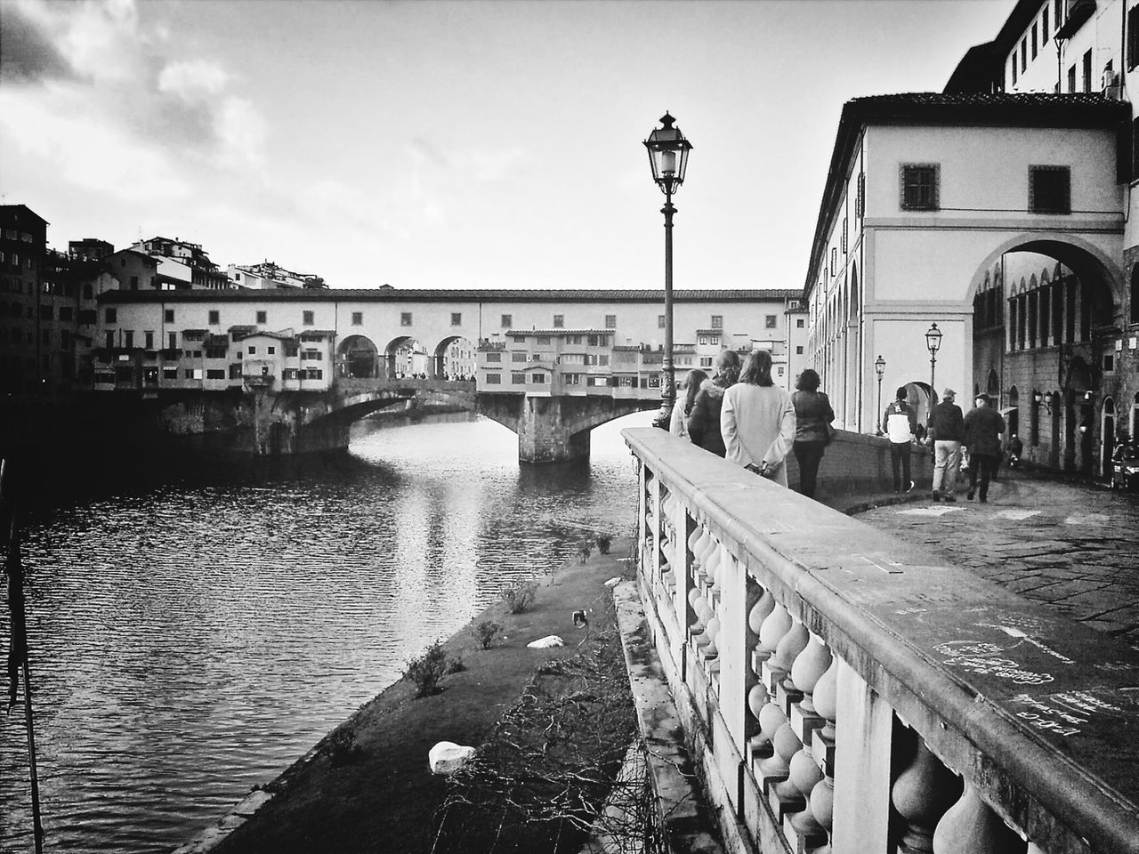 architecture, built structure, water, building exterior, connection, bridge - man made structure, sky, river, city, arch, canal, incidental people, bridge, railing, street light, travel destinations, day, city life, arch bridge