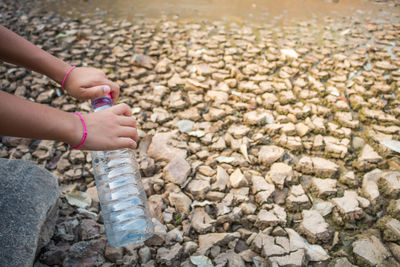 Close-up of girl hand with pebbles