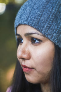 Close-up of thoughtful young woman at park