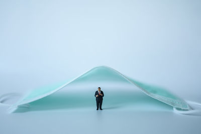 Rear view of man standing against clear sky