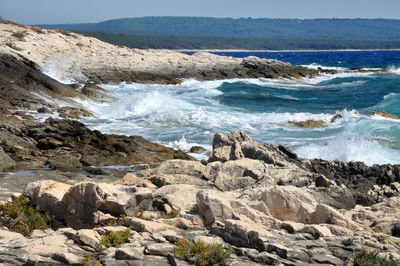 Sea waves washing rocky coastline
