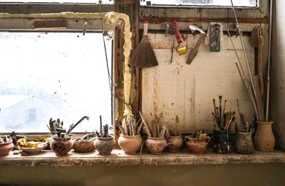 View of various paintbrushes in containers