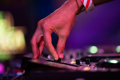 Cropped hand of musician adjusting audio equipment