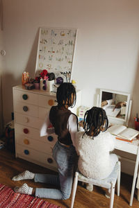 Sisters studying together in study room at home