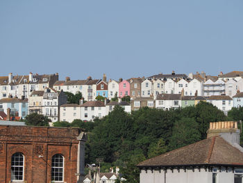 Buildings in city against clear sky