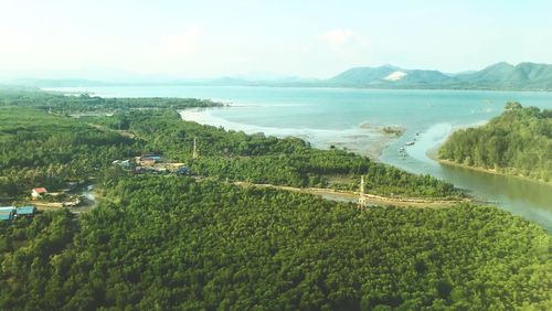 High angle view of sea and mountains against sky