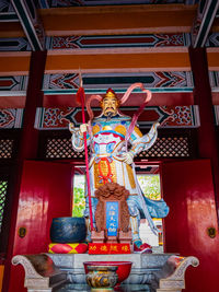 Low angle view of statue against building