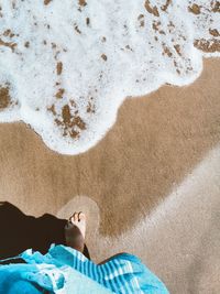 High angle view of man relaxing on beach