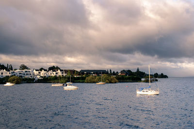 Sailboats in sea against sky