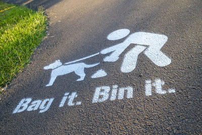 High angle view of arrow sign on road