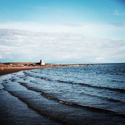 Scenic view of sea against cloudy sky