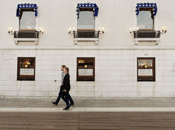 Full length portrait of woman walking in city