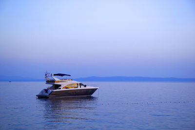 Boat sailing in sea against sky