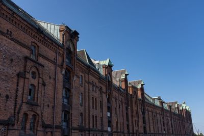 Low angle view of buildings against blue sky