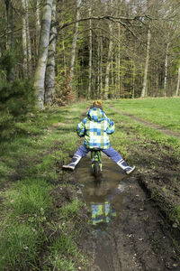 Man with umbrella on grass in forest