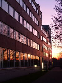 View of illuminated buildings at sunset