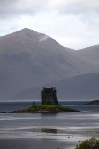 Scenic view of sea against cloudy sky