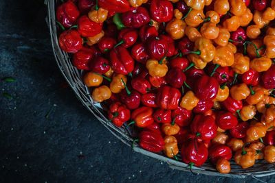 High angle view of bell peppers in basket for sale