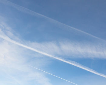 Low angle view of vapor trail in blue sky