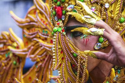 Midsection of man wearing traditional mask