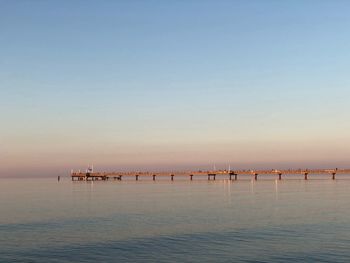 Scenic view of sea against clear sky during sunset