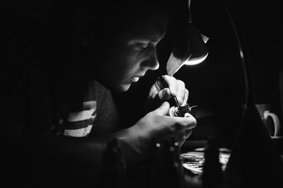Close-up of man repairing equipment