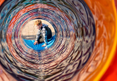 Digital composite image of boy in tunnel
