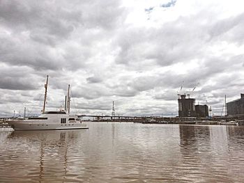 Scenic view of river against cloudy sky