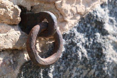 Close-up of rusty metal on rock